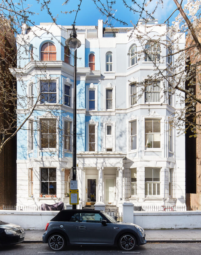 Bright pastel-blue exterior of a two-bedroom apartment for sale in a Notting Hill townhouse