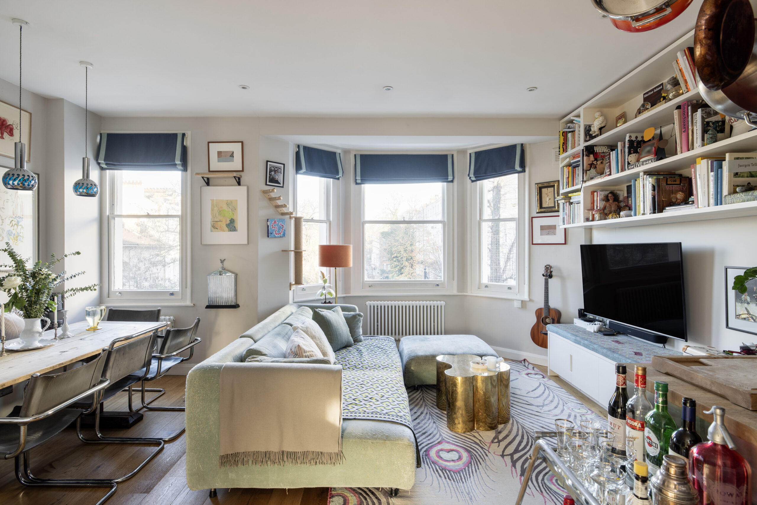 Bright luxury reception room with a large bay window in a one-bedroom Notting Hill apartment for sale