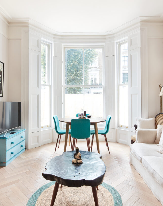 Contemporary reception room with large bay window of luxury apartment for sale in Notting Hill