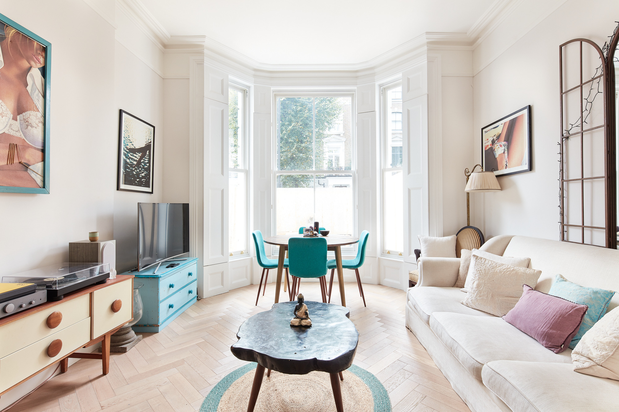 Contemporary reception room with large bay window of luxury apartment for sale in Notting Hill