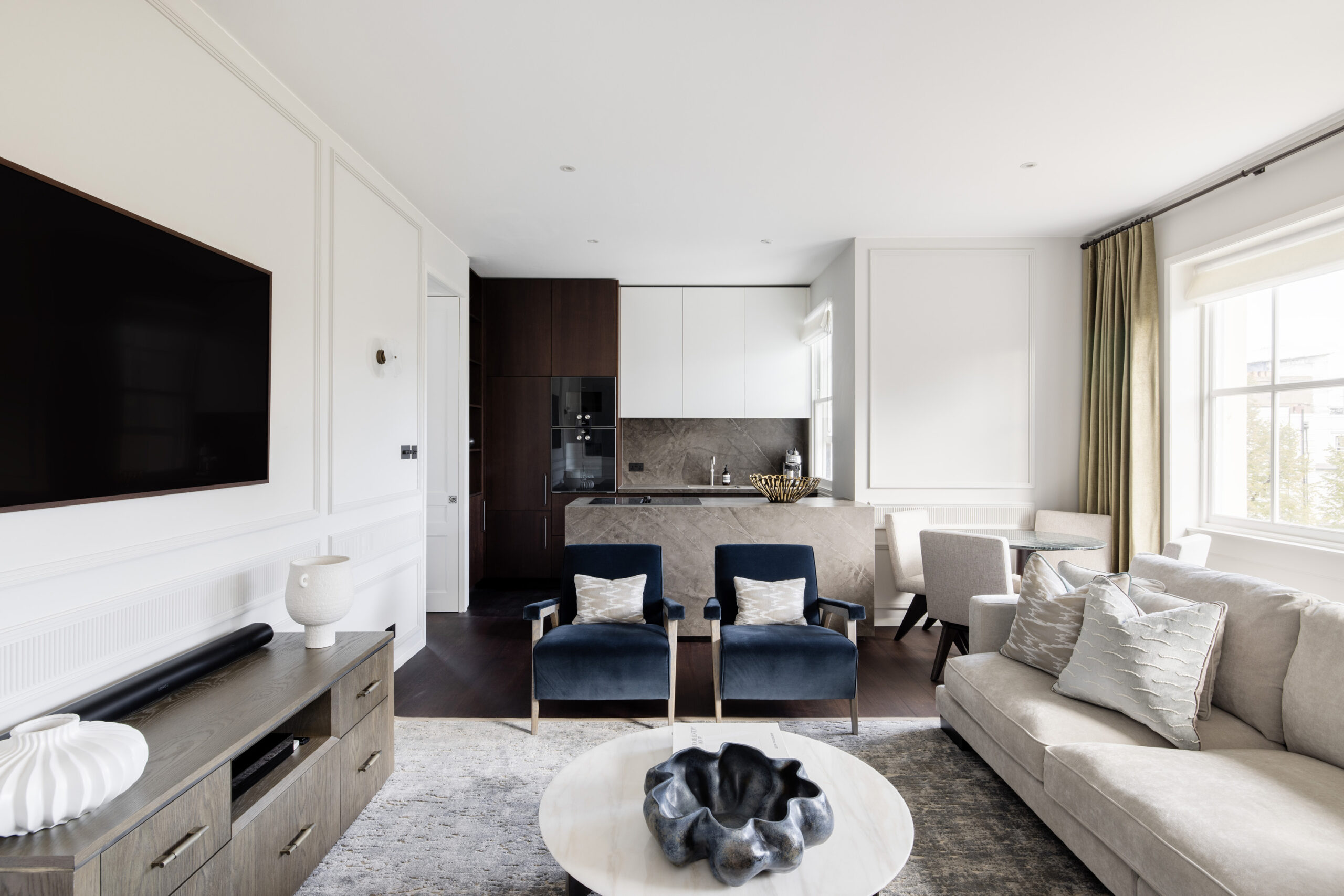 Luxury open-plan kitchen and living room of a two-bedroom apartment for sale in Notting Hill