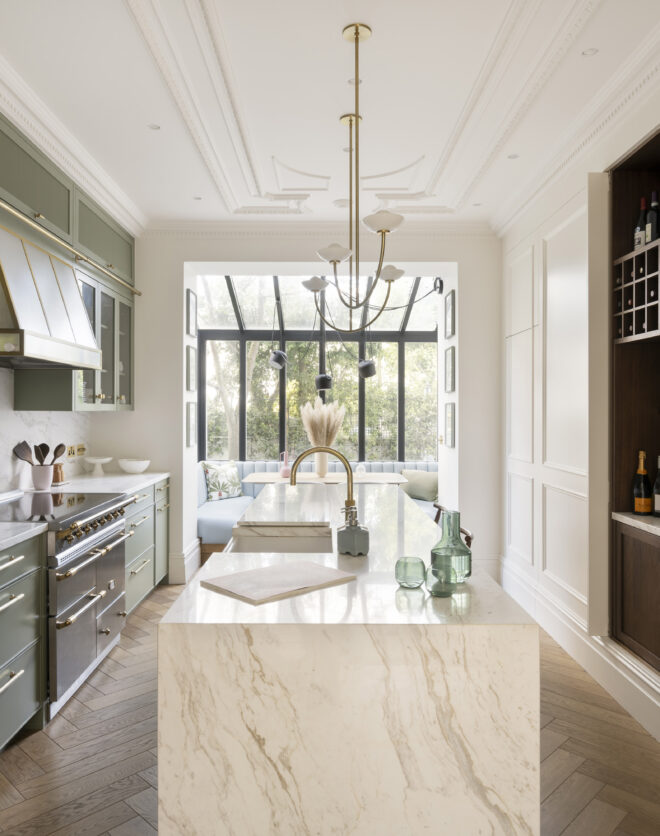 Luxurious sage green and marble kitchen of an elegant two-bedroom duplex apartment for sale in Notting Hill