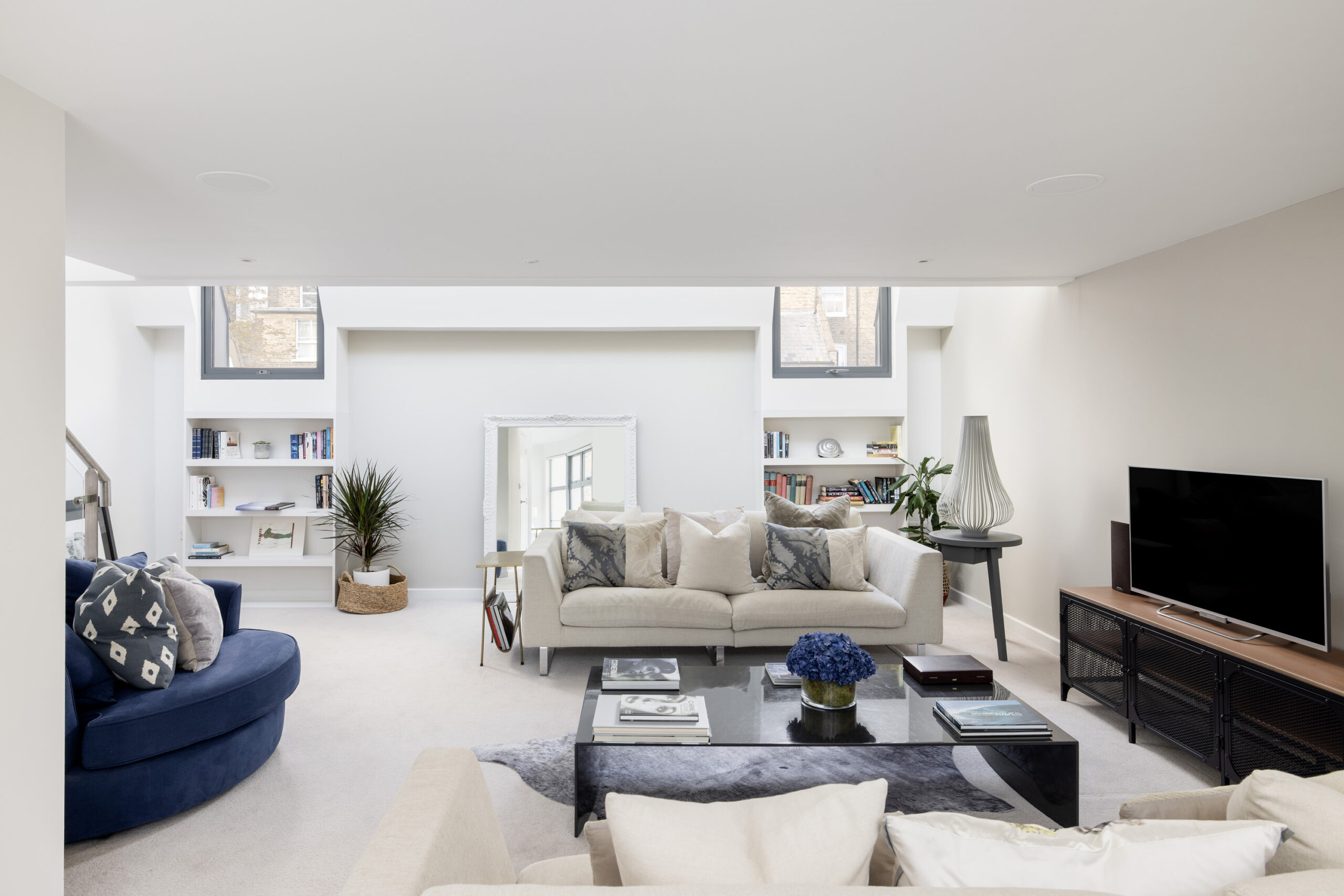 Bright neutral reception room of a three-bedroom mews house for sale in Notting Hill