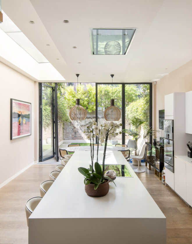 Bright contemporary kitchen with glass doors to a private garden of a four-bedroom luxury Notting Hill townhouse for sale.