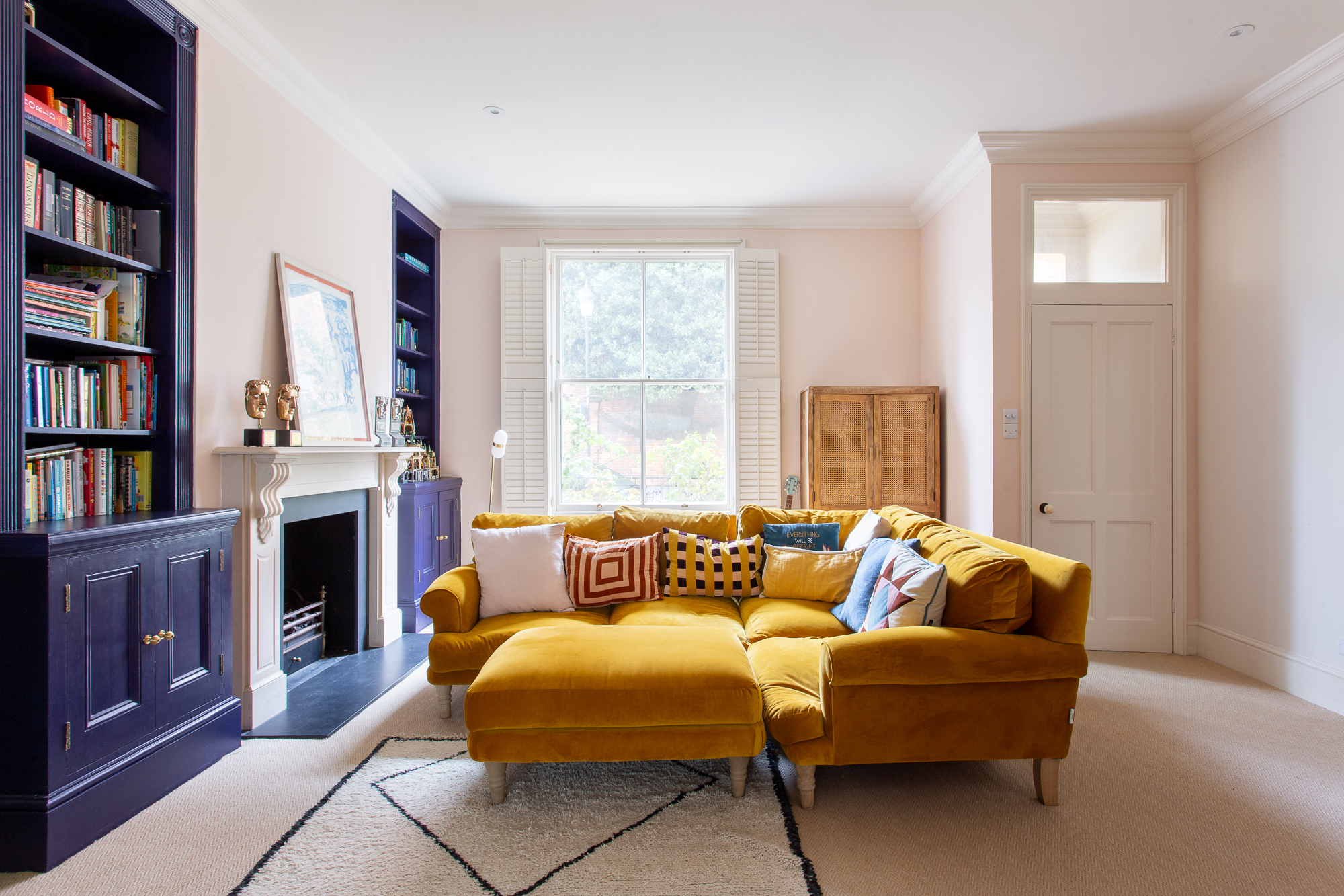Relaxed living room with feature fireplace in a three-bedroom home for sale in Notting Hill
