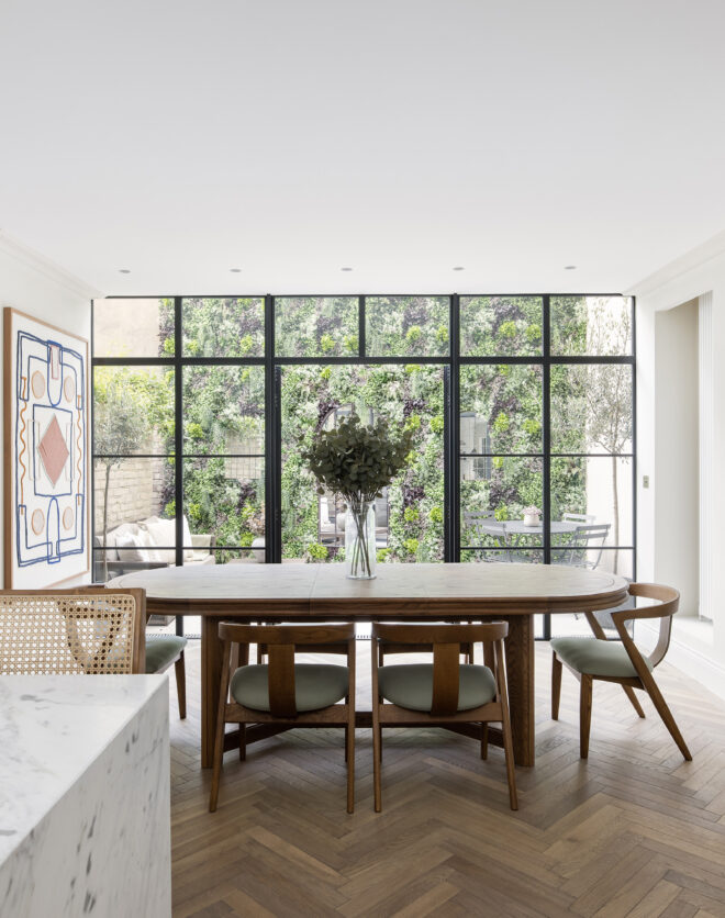 Reception room with a wall of Crittall style glazing, in a three-bedroom home for sale in Notting Hill
