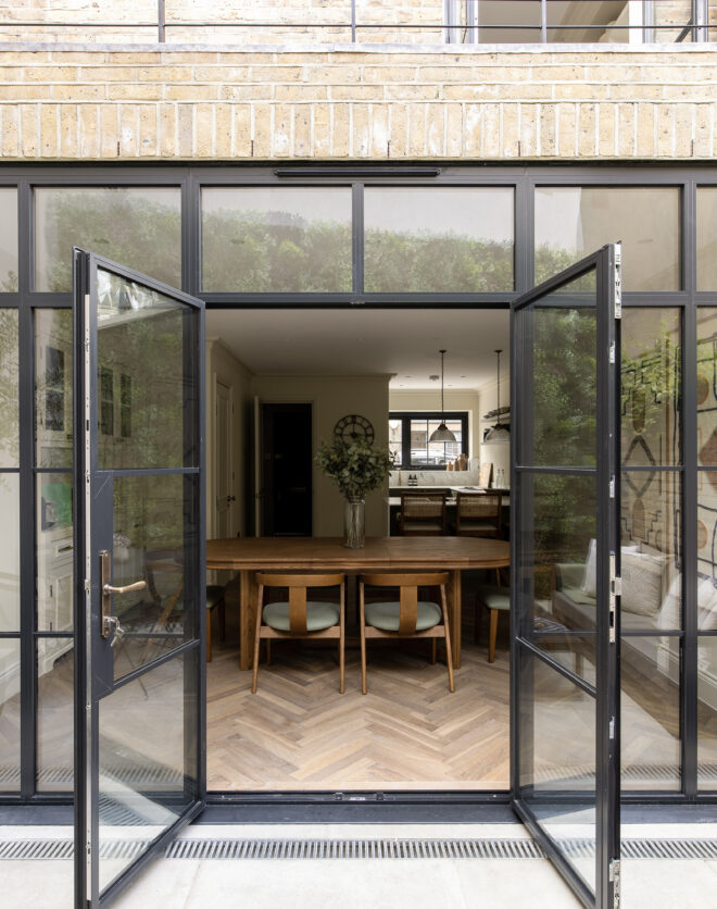 Crittall style glass doors opening to the private garden of a three-bedroom home for sale on Portobello Road