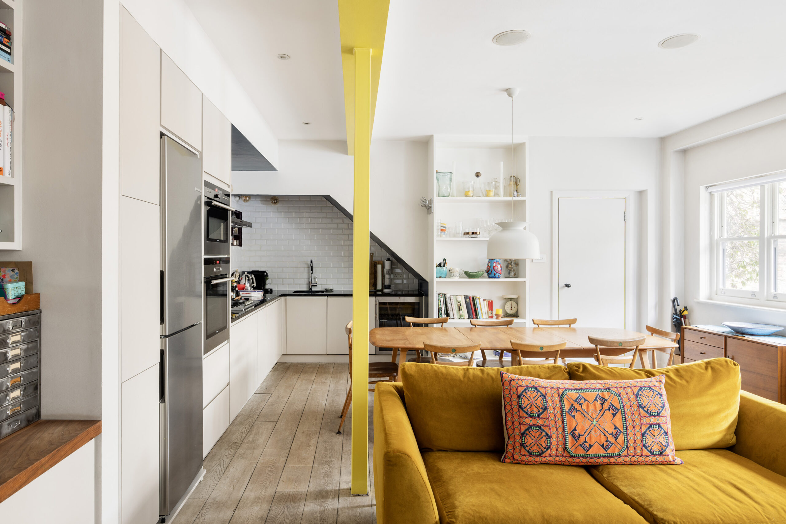 Brightly designed open-plan kitchen, dining and living room of a two-bedroom mews home for sale in Notting Hill