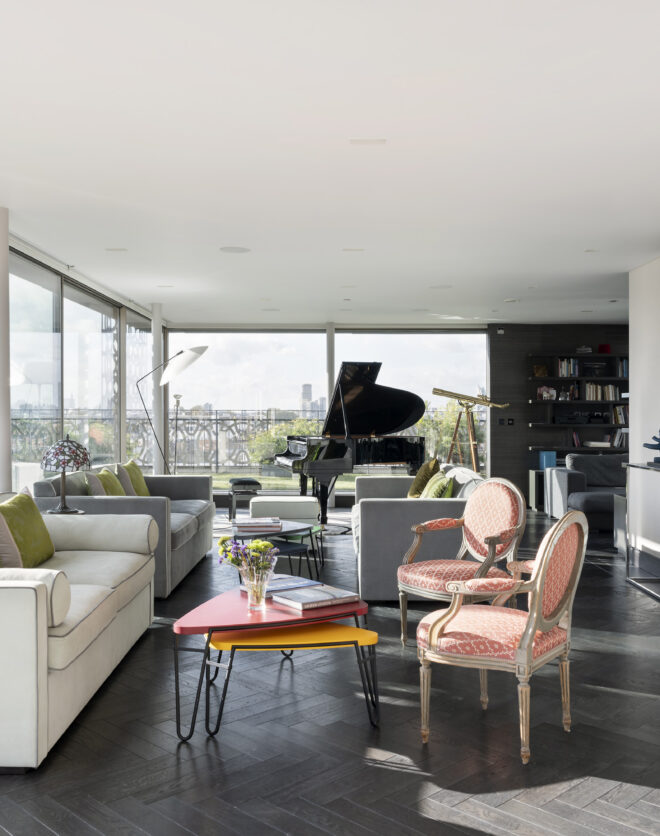 Bright open-plan living space with wraparound glazing leading to a roof terrace in a penthouse apartment for sale on Westbourne Grove