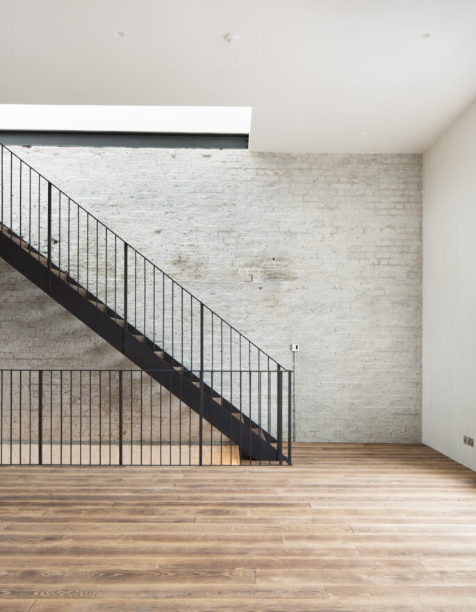 For Rent: Pember House Kensal Green NW10 minimalist staircase and brick wall wood floors