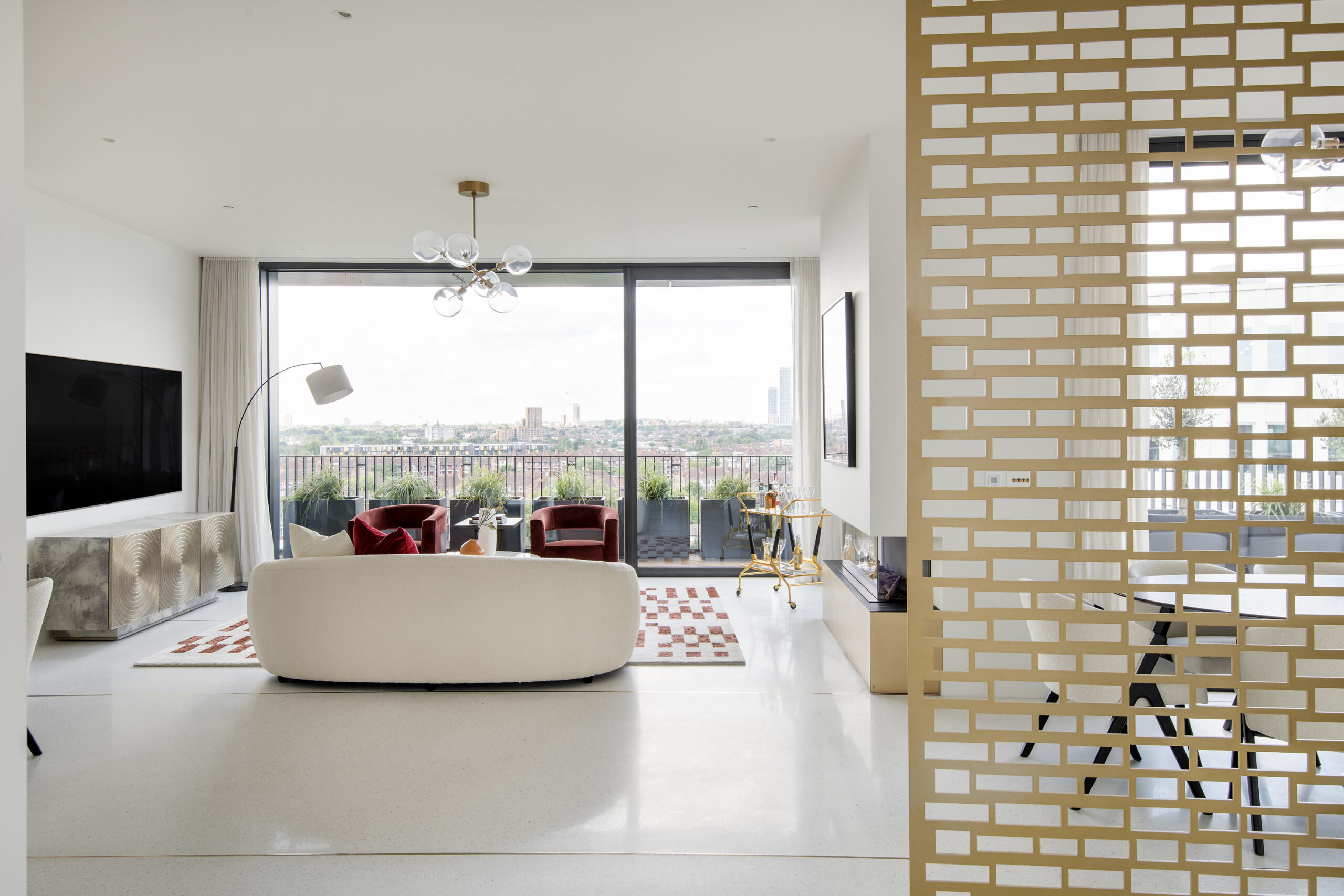 Luxury reception room with glass doors to a roof terrace in a three-bedroom penthouse apartment for rent in White City