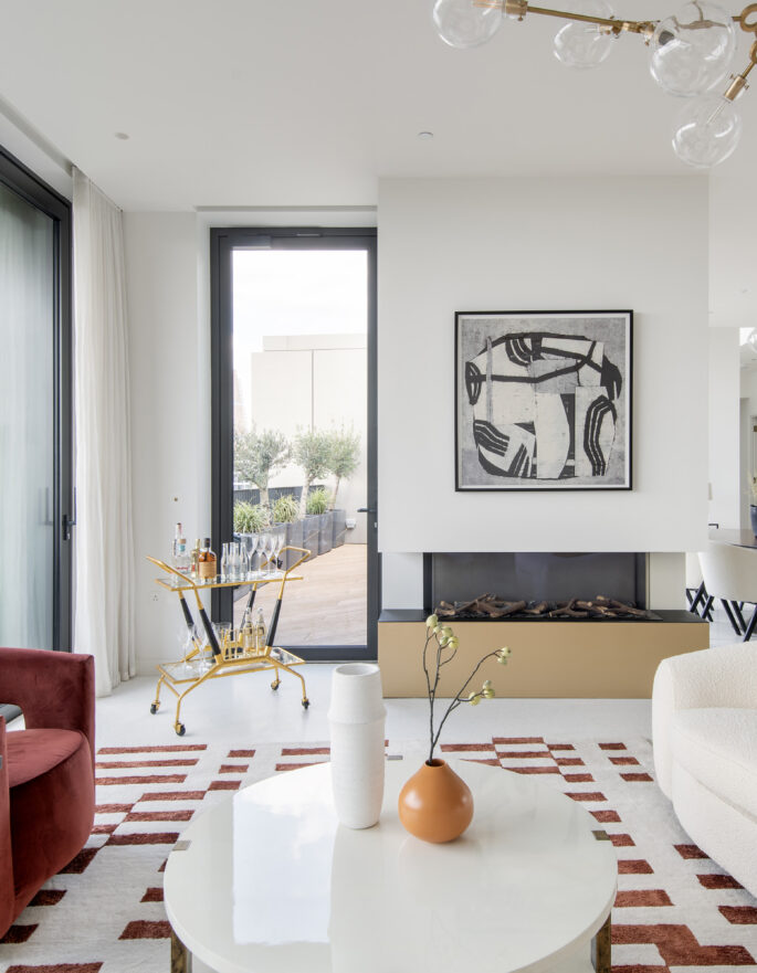 Luxury reception room with glass doors leading to a roof terrace in a three-bedroom penthouse apartment for rent in White City