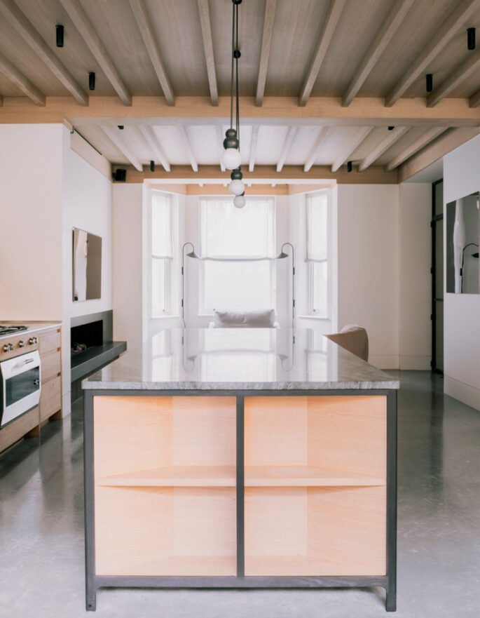 Kitchen with exposed rafters by Stiff + Trevillion