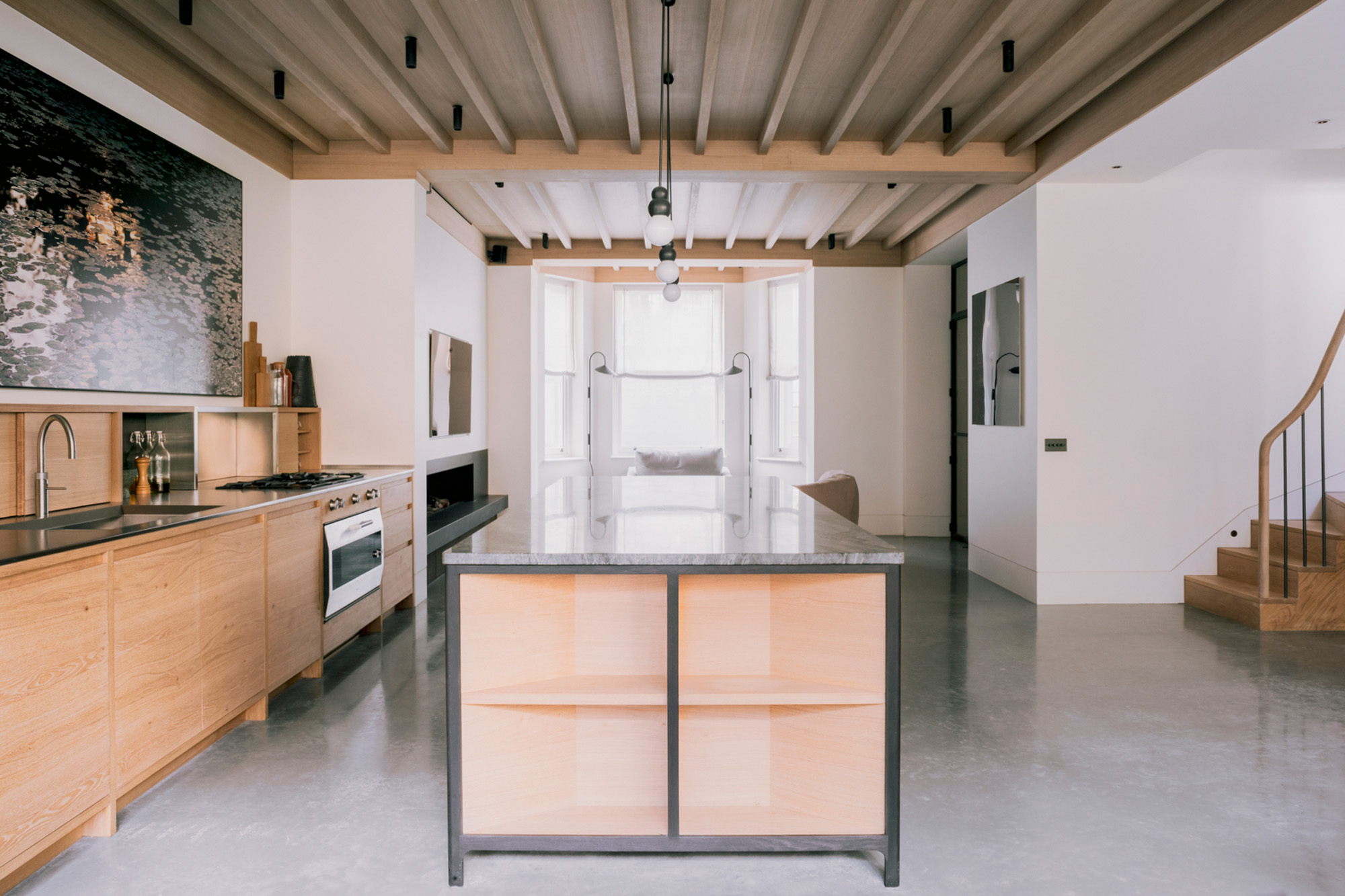 Kitchen with exposed rafters by Stiff + Trevillion