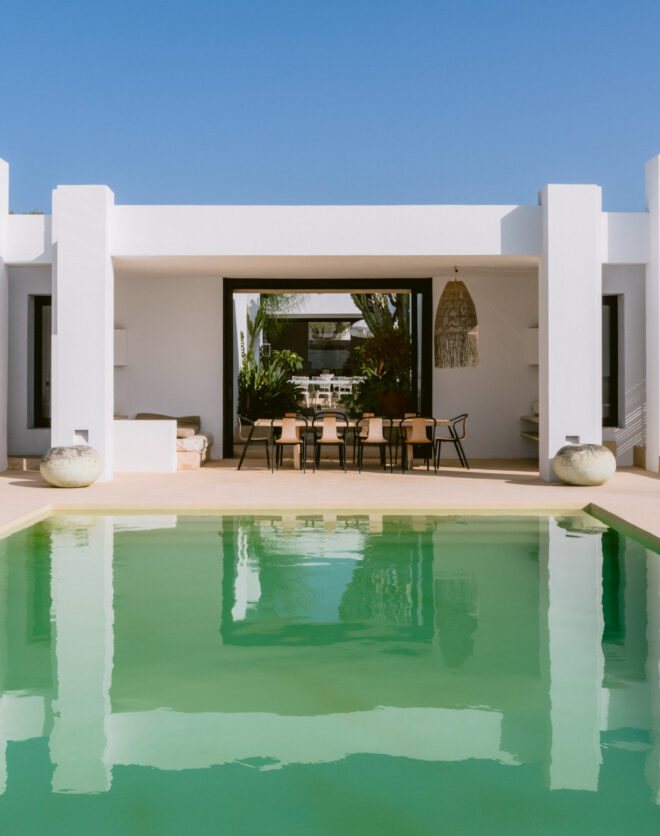 Eye-catching André Jacqmain villa for sale, reflected in its expansive pool