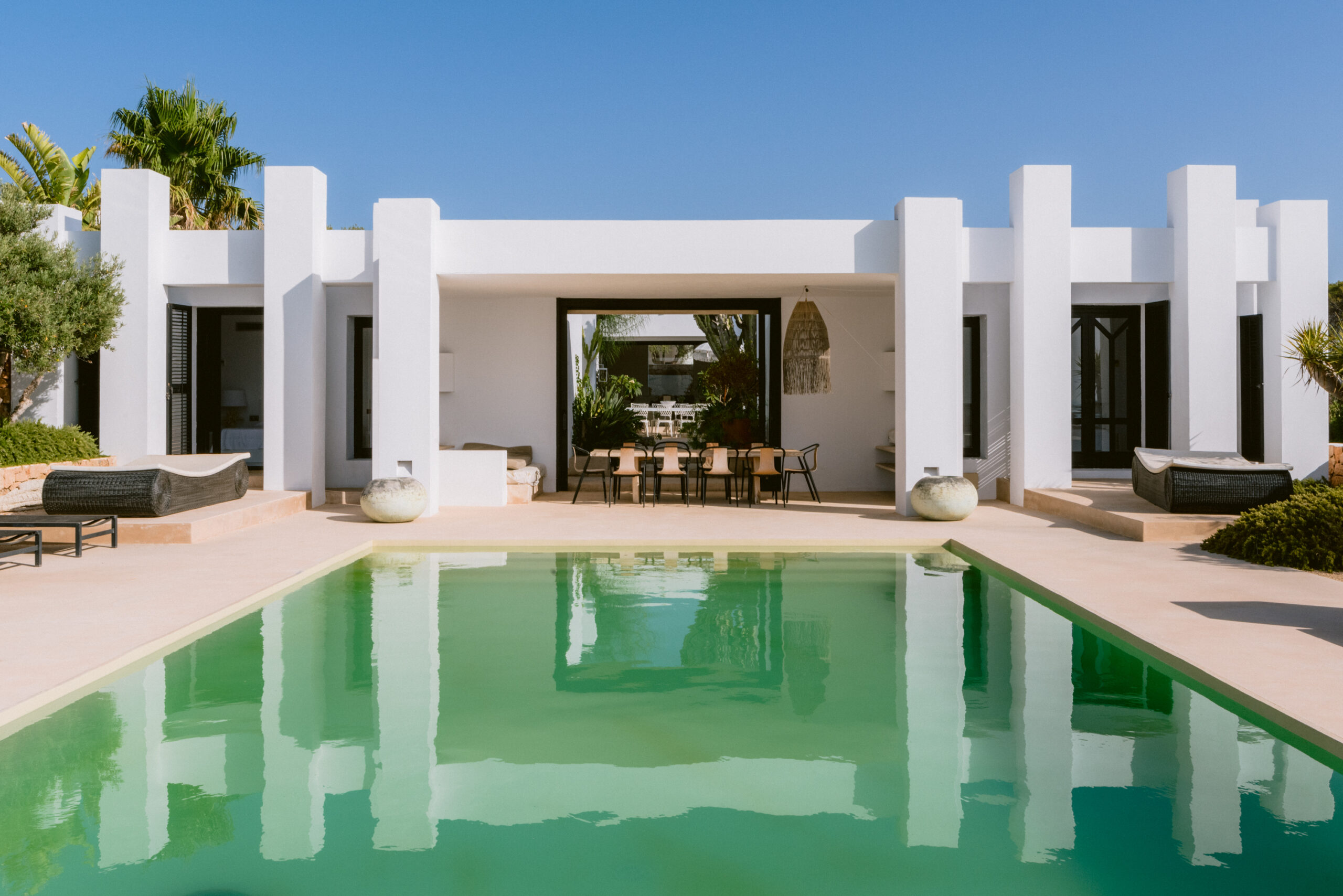 Eye-catching André Jacqmain villa for sale, reflected in its expansive pool