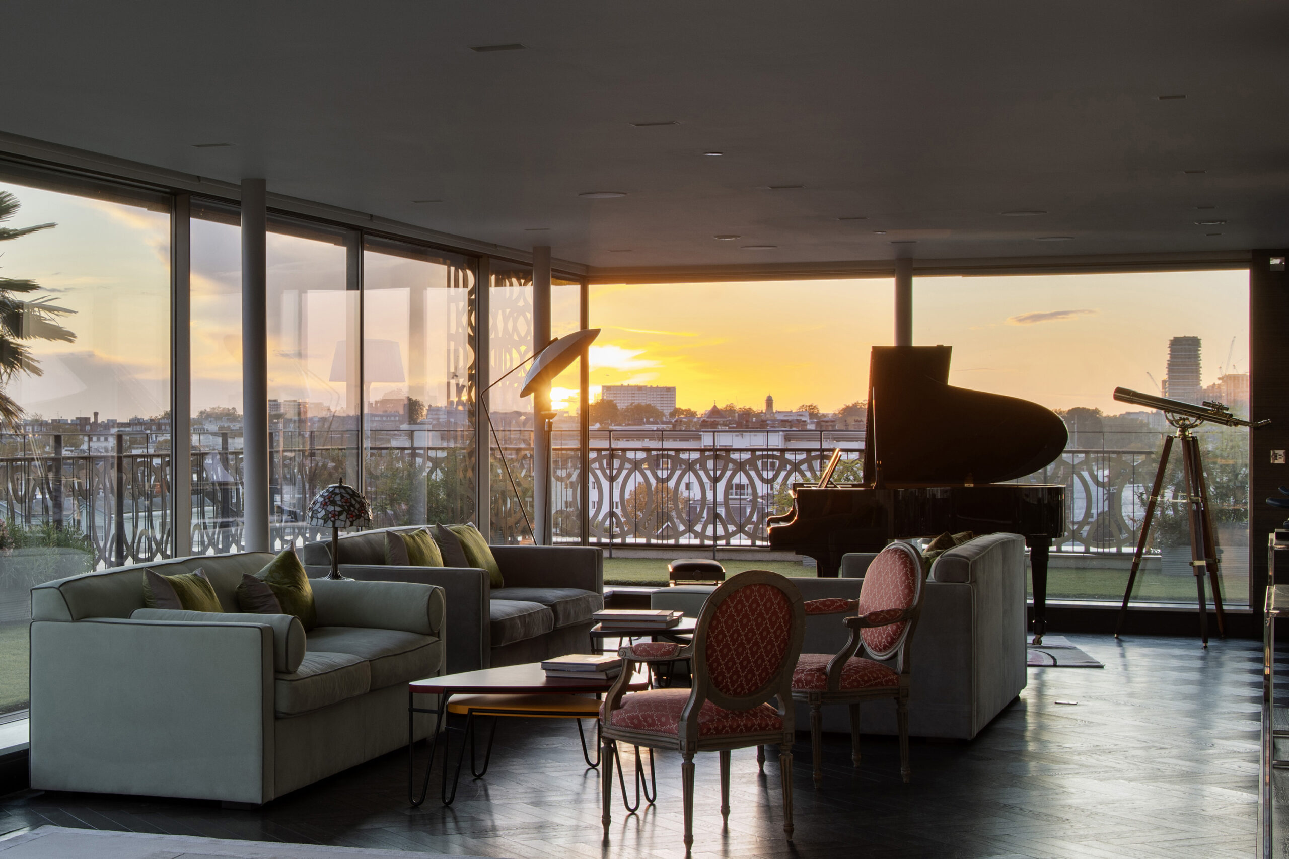 Dusk shot of the reception room in a penthouse apartment for sale on Westbourne Grove