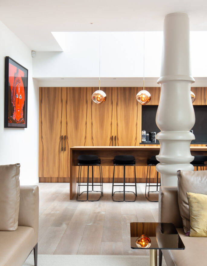 Kitchen in Westbourne Grove with oversized column and Tom Dixon chandeliers