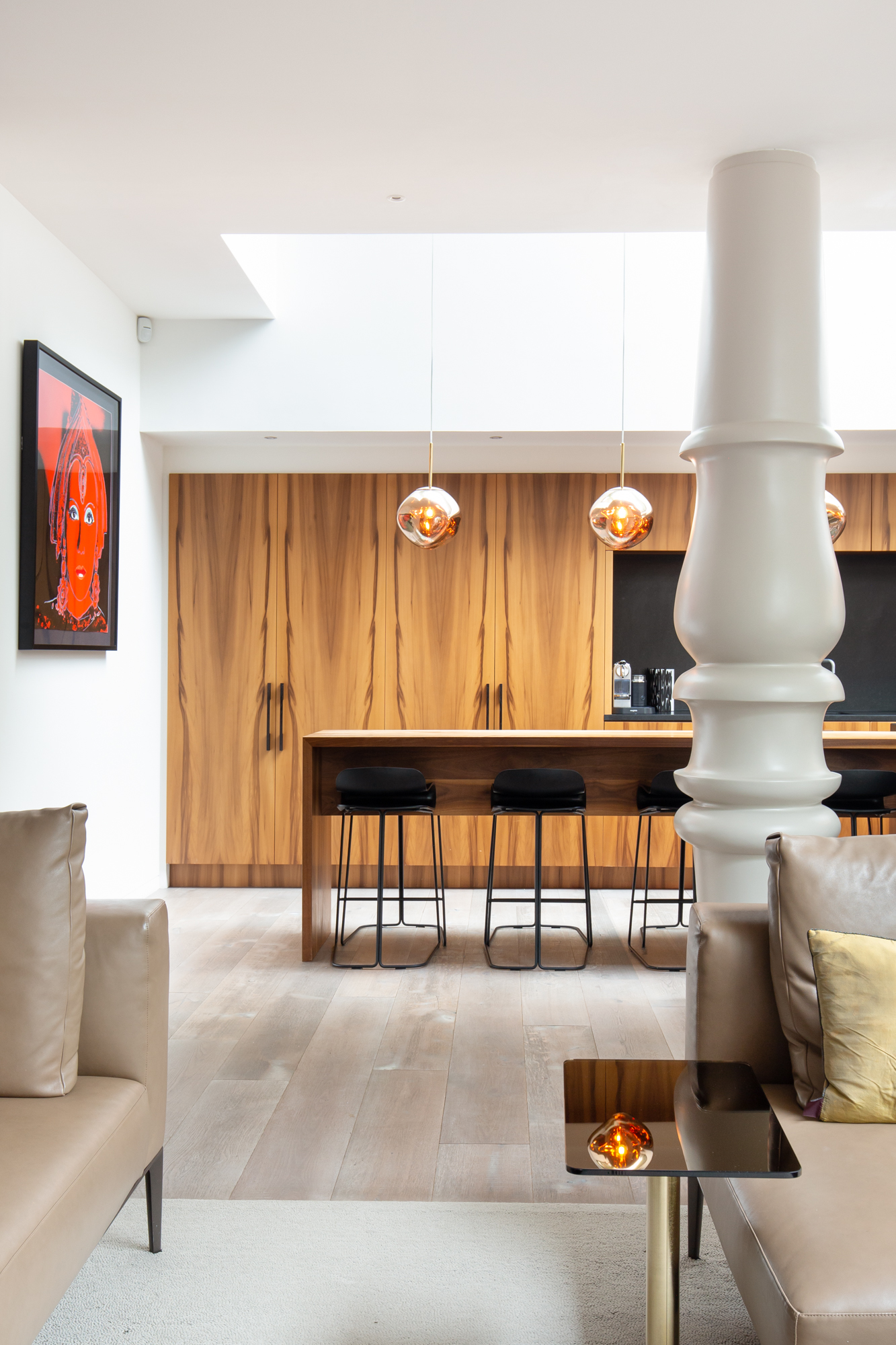 Kitchen in Westbourne Grove with oversized column and Tom Dixon chandeliers