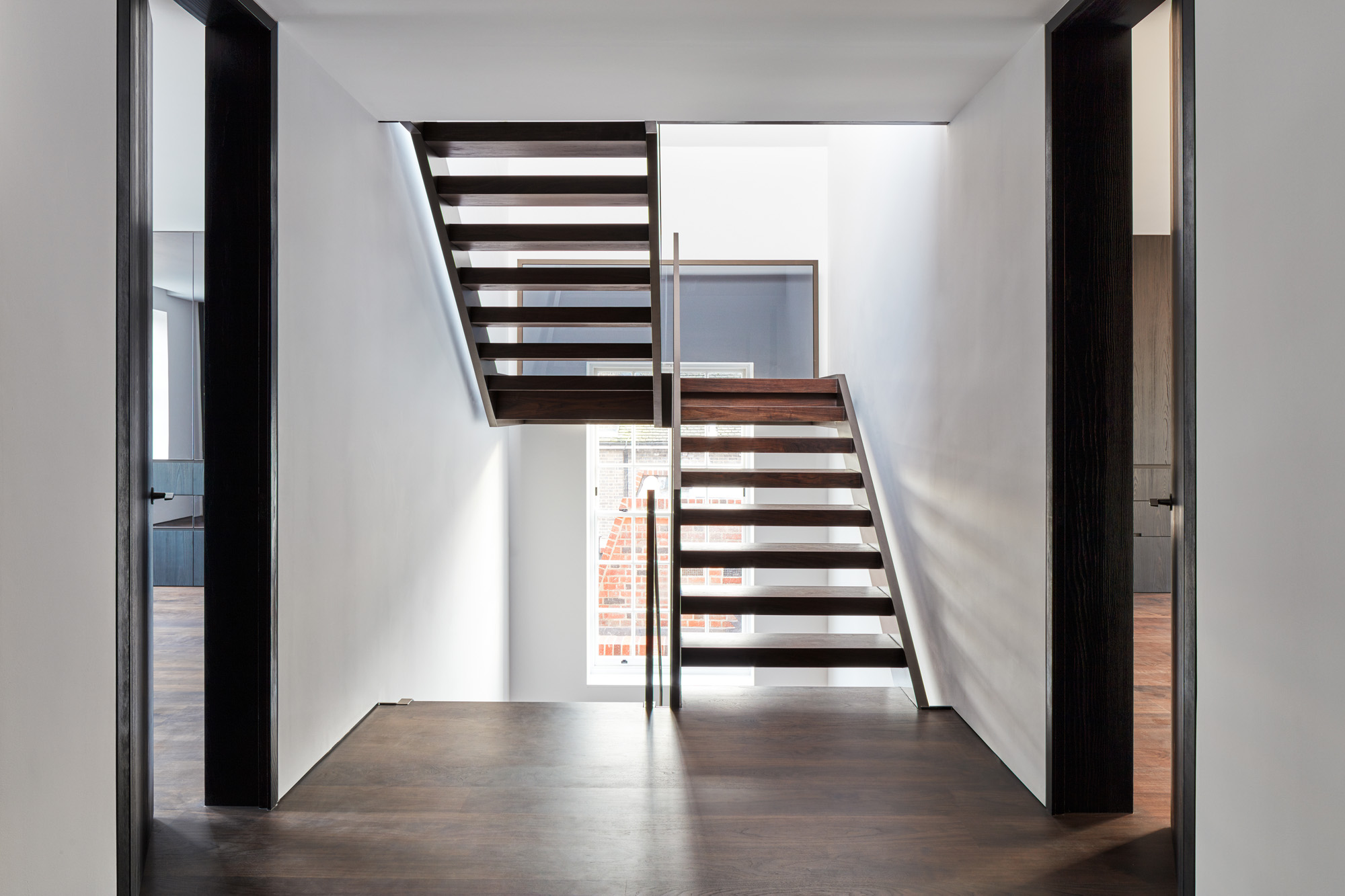 Slatted stairs connect floors in a modern house