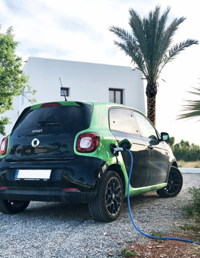 Electric car charging outside an Ibiza villa