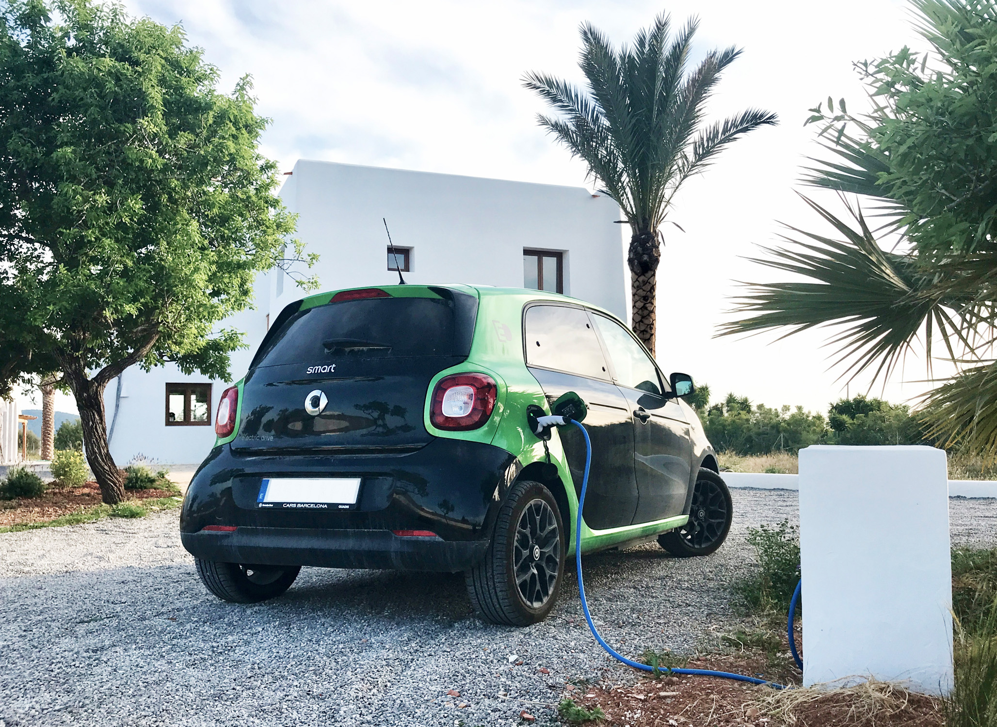 Electric car charging outside an Ibiza villa