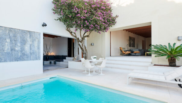Turquoise swimming pool ties together the courtyard of a luxury townhouse in Ibiza Town