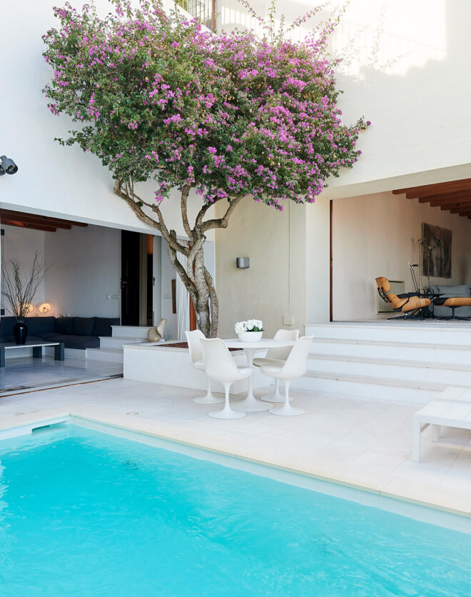 Turquoise swimming pool ties together the courtyard of a luxury townhouse in Ibiza Town